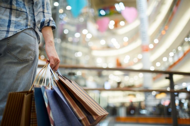 Woman holding shopping bags in the mall.